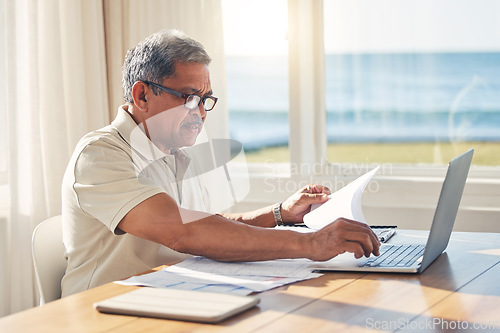 Image of Senior man, laptop and documents in budget planning, schedule payment or checking bills at home. Mature male person working on computer, paperwork or expenses in finance, insurance or retirement plan