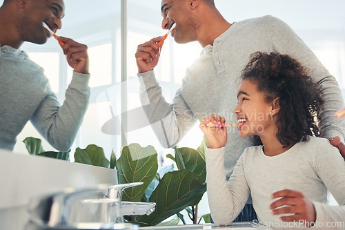 Image of Dad, girl and kid brushing teeth in bathroom for hygiene, morning routine or learning healthy oral habits. Happy father, child and dental cleaning at mirror with toothbrush, self care or fresh breath