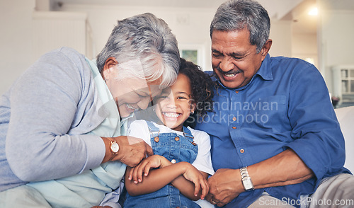 Image of Grandparents tickling child, happiness and funny, relax at home at the weekend with retirement and love. Fun, playful and old people with young kid on sofa in living room, laughter and bonding