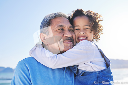 Image of Grandfather, child and happy at the beach for vacation and travel together on outdoor holiday for happiness. Hug, smile and grandparent with kid or young grandchild by the ocean or sea for adventure