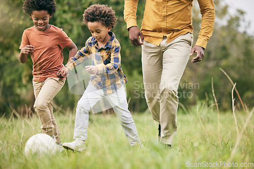 Image of Family, ball and a boy playing soccer on a field outdoor for fun together with his happy brother. Football, fitness or game with a father and children running on grass for sport or physical activity