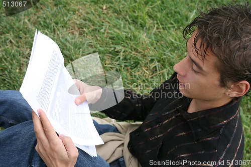 Image of student reading outdoors