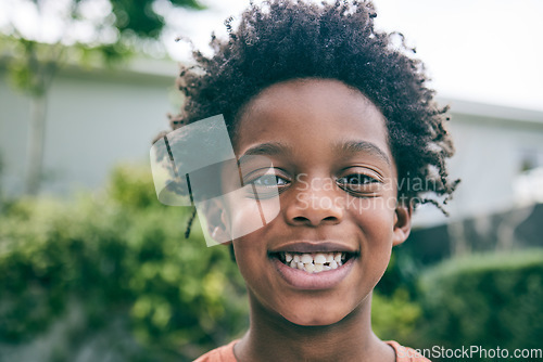 Image of Portrait, kid and face of boy outdoor in garden, park and backyard of home for fun, good mood and smile. Happy, confident and african child relax in neighborhood for freedom, joy and play in Nigeria