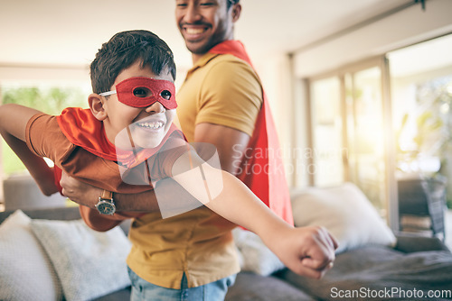 Image of Dad, boy and superhero game in living room, flying and power with smile, care and bonding in house. Father, young son and mask with comic laugh, playful and lift in air, lounge and family home