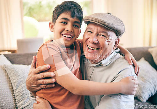 Image of Happy, hug and portrait of child with his grandfather on a sofa in the living room for relaxing and bonding. Smile, love and senior man sitting and embracing a boy kid in the lounge of family home.