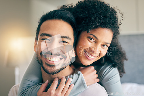 Image of Couple, portrait and hug in bedroom, smile and love with bonding, care and trust in healthy relationship. Interracial, people relax at home and happy, romance and partner with marriage and commitment