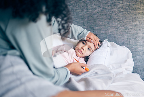 Image of Mother, thermometer and sick child in bedroom with illness, virus or infection and caring parent at home. Mom checking kid or little girl with fever, cold or flu in health or medical attention in bed