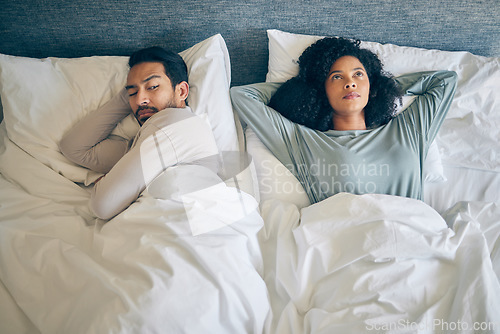 Image of Interracial couple, fight and stress in bedroom for divorce, anger and thinking of breakup, cheating and anxiety from above. Man, woman and partner in bed for conflict, argument and drama of dispute