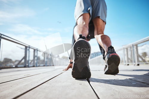 Image of Fitness, running and a the back of a man at the start of his workout in the city for cardio or endurance training. Exercise, bridge and shoes of a male runner or athlete outdoor for a challenge