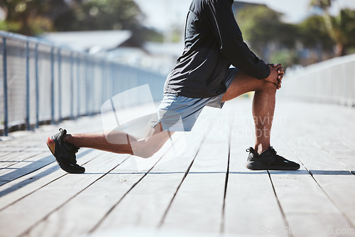 Image of Closeup, city and man stretching, legs and training with warm up, sports and workout with wellness. Zoom, healthy person and runner with exercise, stretch and energy with fitness, challenge and lunge