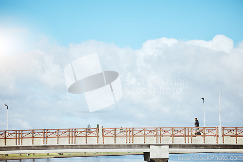 Image of Fitness, sky and a man running on a bridge for a cardio or endurance workout on cloud mockup space. Exercise, sports and training for a marathon with a male runner or athlete outdoor for a challenge