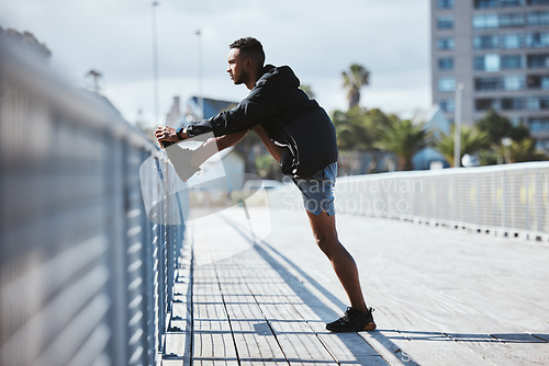 Image of Workout, outdoor and man stretching, fitness or training with warm up, bridge and exercise with health. Athlete, person or runner in a city, stretch and wellness with practice, body or morning cardio