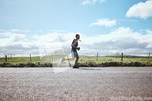 Image of Training, marathon runner and man on road outdoor, cardio or healthy body. Athlete, sport and fitness exercise in competition, workout energy or race on street in wellness at countryside mockup space