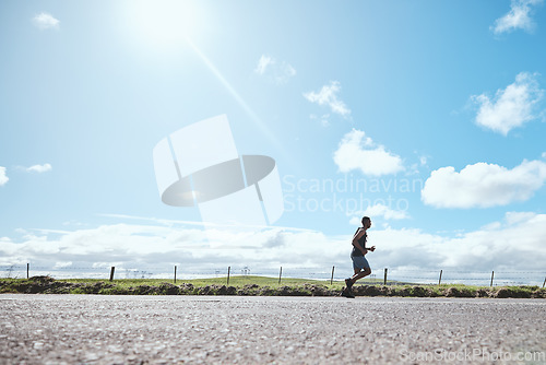 Image of Marathon runner, fitness and man on road outdoor, cardio or healthy body. Athlete training, sport and exercise in competition, workout energy or race on street in wellness at countryside mockup space