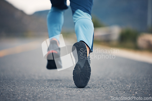 Image of Street, legs and fitness person running for outdoor exercise, cardio workout or training for marathon race on asphalt road. Sports shoes, athlete foot steps or feet of closeup runner doing challenge