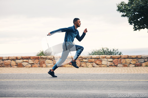 Image of Runner man, sprint and outdoor in street, nature and profile for speed, fitness and exercise. Athlete guy, fast running and vision on road for workout, training and sports for health in countryside