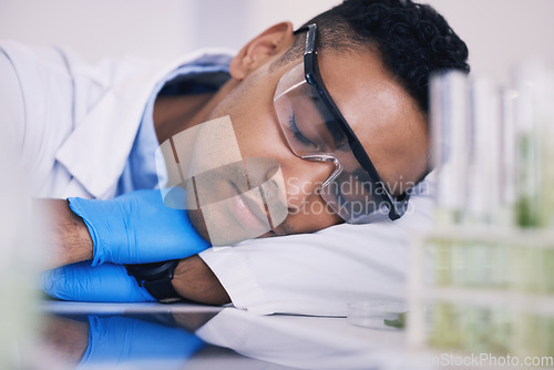 Image of Scientist, man sleeping and tired in laboratory for plants research, medicine and pharmaceutical study at table. Medical or science person with career dream, fatigue and depression by green test tube
