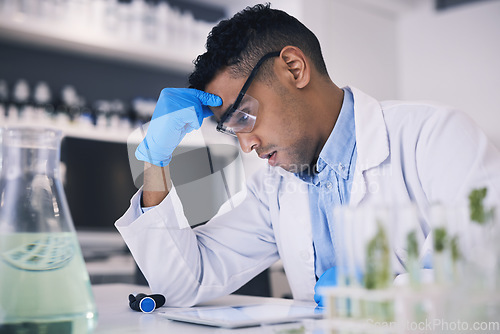 Image of Stress, science and a man with burnout in a laboratory for research or innovation in medicine. Thinking, problem solving and a male scientist working to a deadline in a lab for medical breakthrough