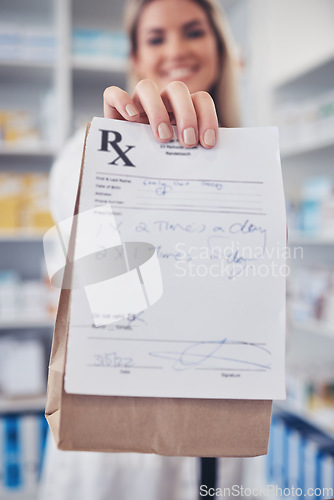 Image of Pharmacy, hand and prescription medicine with paper in a bag for healthcare, drugs and pharmaceutical. Closeup of a pharmacist or medical worker with rx information, drugstore and retail service