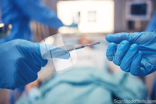 Image of Hands, scalpel for surgery and collaboration in a hospital during an operation or emergency medical procedure. Teamwork, healthcare equipment and doctors in theatre together to save a patient closeup