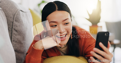 Image of Asian woman, selfie and lying on sofa with peace sign and love for profile picture, vlog or social media at home. Happy female relaxing with smile and hand signs for photo or online vlogging on couch