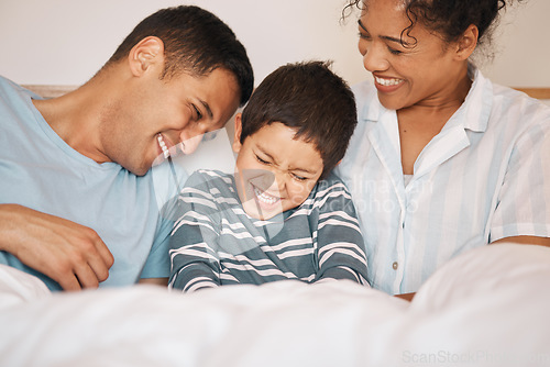 Image of Happy, tickle and funny with family in bedroom for playful, morning and love. Care, support and wake up with parents and boy child laughing in bed at home for weekend, positive and relax together