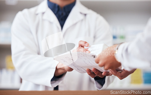 Image of Healthcare, pharmacy and prescription medicine in hand of customer with paper, box or rx medication. Closeup of pharmacist or medical staff with person for pharmaceutical product at retail drugstore