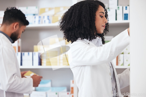 Image of Healthcare team, pharmacy and medicine on shelf for pills, tablets or medication inspection or inventory. Pharmacist woman or medical staff check stock or pharmaceutical product at drugstore or work