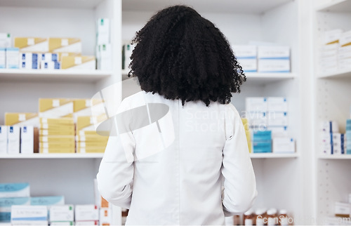 Image of Healthcare woman, pharmacy and medicine on shelf with pills or medication for inspection or inventory. Back of pharmacist person or medical staff to check stock or pharmaceutical product at drugstore