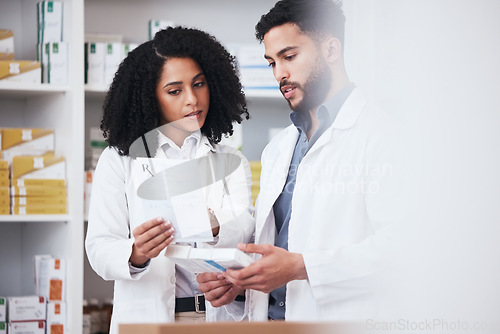 Image of Healthcare, medicine and a pharmacist team with a box of prescription or chronic medication in a drugstore. Medical, pharmaceutical product and a medicine professional in a pharmacy with a colleague