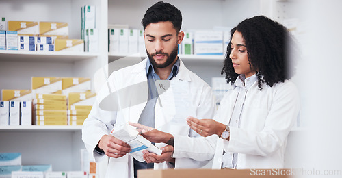 Image of Healthcare, medicine and a pharmacy team with a box of prescription or chronic medication in a drugstore. Medical, pharmaceutical product and a pharmacist in a clinic with a colleague for health