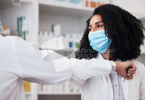 Image of Elbow greeting, face mask and doctors at a pharmacy for a hello, conversation or medical communication. Morning, nursing and people in healthcare with a handshake for safety from virus at a clinic