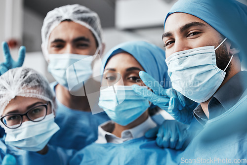 Image of Healthcare, teamwork and surgery, selfie in operating room in medical emergency at hospital. Face of doctor, nurses and surgical team taking picture in operation with ppe, face mask and scrubs.