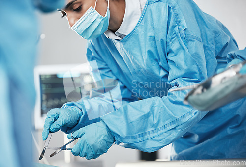 Image of Healthcare, medical and doctor in surgery with surgical tools or equipment in the hospital. Surgeon, cardiology and woman cardiologist doing heart operation or procedure on patient in medicare clinic