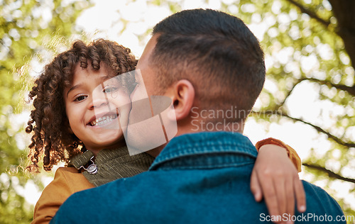 Image of Kiss, portrait and a child and father in nature with a hug for playing, bonding or family. Happy, together and a young dad with care, love and carrying a girl kid in a park for outdoor walking