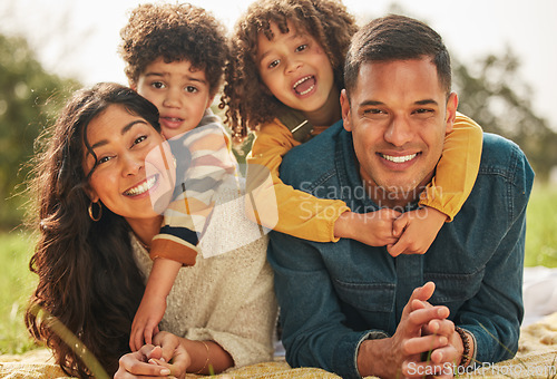 Image of Happy family, parents or couple with kids in a park together and happy for vacation or outdoor vacation. Picnic, portrait and mother bonding with children and father in nature for summer travel