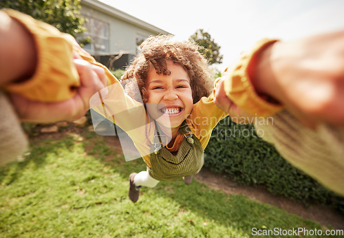 Image of Kid, spin and outdoor in pov, holding hands and happy for game with parent, holiday or backyard. Excited young child, smile and swing in air, fast and grass for play on vacation, sunshine or portrait