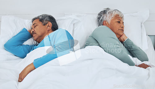 Image of Sleeping, fighting and a senior couple in a bed with insomnia in a marriage together. Conflict, tired and elderly man and woman in the bedroom for rest in divorce and a nap with thinking in a house