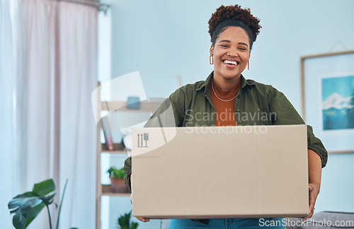 Image of African woman, box and new house with moving, portrait and smile for fresh start, logistics and excited face. Girl, cardboard package and happy in living room, home and investing in real estate