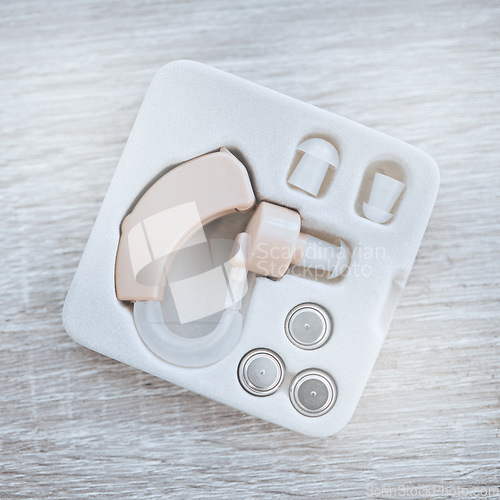 Image of Hearing aid, healthcare and box for ear device with disability, medical equipment or sound. Audiology, deafness and technology for audio, wellness or medicine industry with modern listening accessory