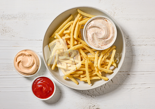 Image of french fries with various dip sauces