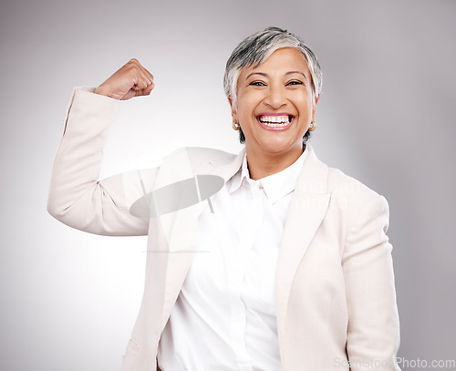 Image of Strong, smile and portrait of businesswoman in a studio with strength or confidence gesture. Happy, excited and mature female model from Mexico flexing arm muscles for empowerment by gray background.