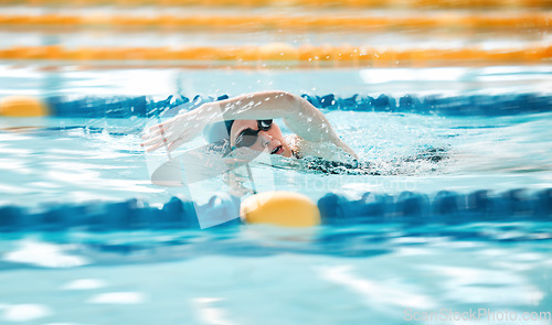 Image of Woman, pool and swimming in sports fitness, exercise or training in water splash or athletics. Female person, athlete or professional swimmer in competition, race or marathon in workout practice