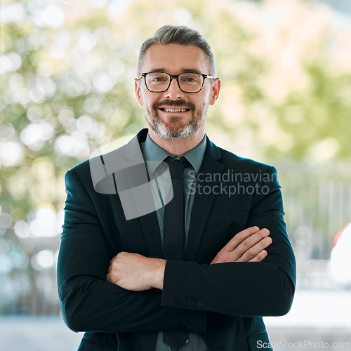 Image of Portrait, smile and arms crossed with a business man outdoor in the city for corporate management or work. Leadership, happy and confidence with a mature manager or professional boss in an urban town