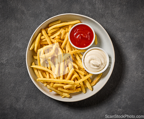 Image of plate of french fries with ketchup and mayonnaise