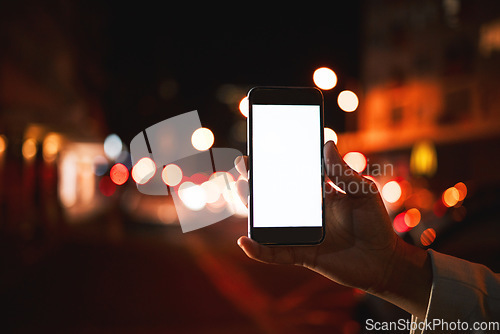 Image of Closeup, mockup and hand with a smartphone, night and social media with digital marketing, chatting and email notification. Dark, evening and outdoor with a person, cellphone and mobile app for sms