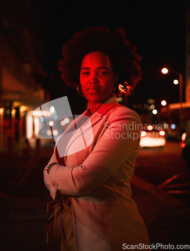 Image of Portrait of black woman, city and night lights, standing in dark street and waiting for taxi with bokeh. Urban business fashion, late travel in Africa and serious girl in road with neon red lighting.