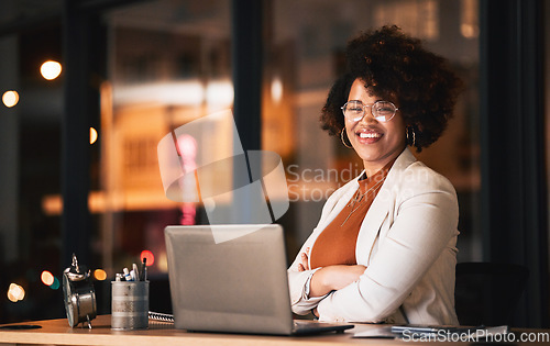 Image of Business woman, face and arms crossed on laptop for night planning, marketing research and online management. Professional african person or editor portrait on computer with career mindset and bokeh