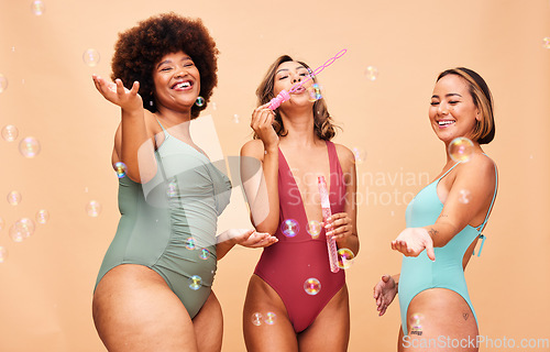Image of Blowing bubbles, woman and summer party with inclusion of friends in studio background or swimming, fashion or swimsuit body. Group, playing and diversity of women beauty on fun vacation or skincare
