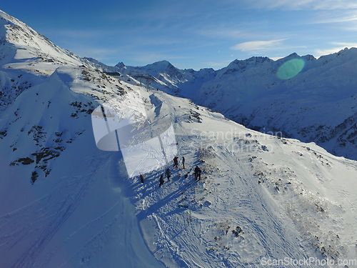 Image of Morning, people and mountains with snow in the winter for travel, climbing and hiking. Outdoor, ski and the view of a natural environment with a blue sky in the Alps in Europe for adventure on rocks